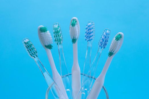 Toothbrushes on blue background. Dental care concept