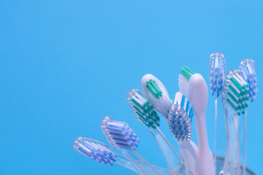 Toothbrushes on blue background. Dental care concept