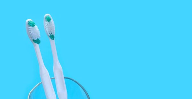 Toothbrushes on blue background. Dental care concept