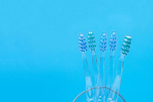 Toothbrushes on blue background. Dental care concept