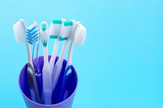 Toothbrushes on blue background. Dental care concept