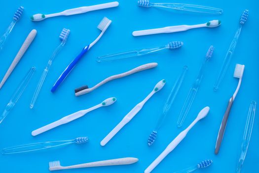 Toothbrushes on blue background. Dental care concept