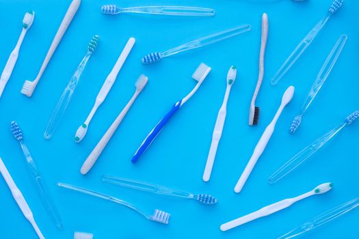 Toothbrushes on blue background. Dental care concept