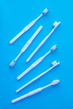 Toothbrushes on blue background. Dental care concept