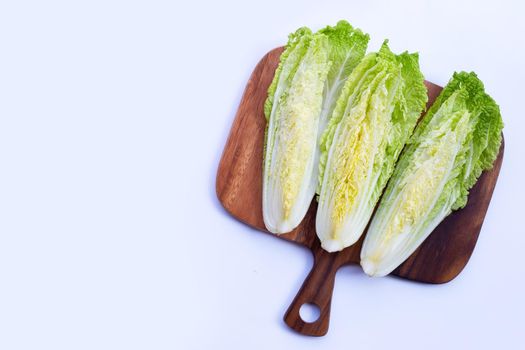Chinese cabbage on wooden cutting board on white background. Copy space