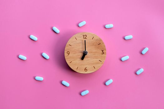 Clock with "PrEP" ( Pre-Exposure Prophylaxis). used to prevent HIV on pink background.