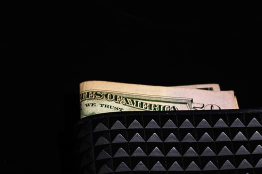 Dollars money banknotes in a black wallet isolated.