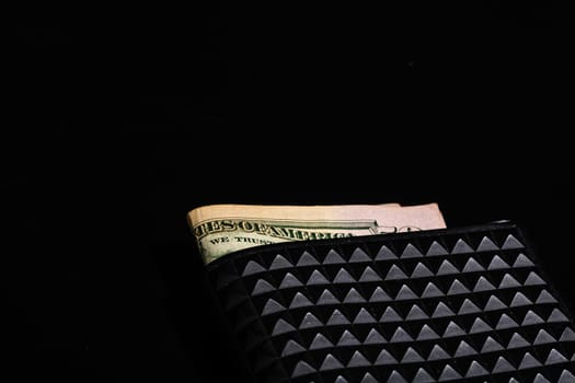 Dollars money banknotes in a black wallet isolated.