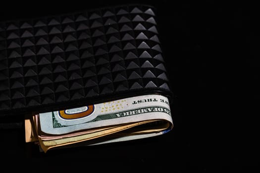 Dollars money banknotes in a black wallet isolated.