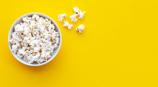 Popcorn on yellow background. Copy space