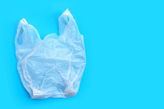 White plastic bag on blue background. Copy space