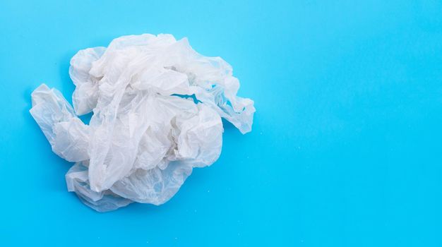 Crumpled plastic bags on blue background. Copy space
