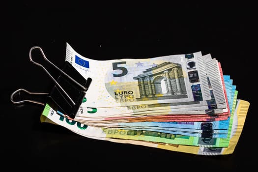 Close up on stack of EURO money. Euro banknotes isolated.