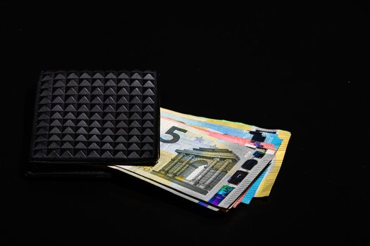 Euro banknotes in black wallet isolated.