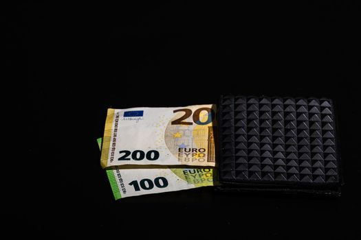100 euro and 200 euro banknotes in black wallet isolated