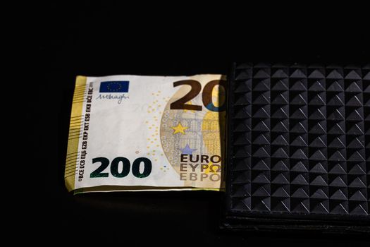 200 Euro banknotes in a black wallet isolated.