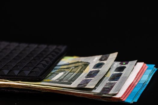 Euro banknotes in black wallet isolated.