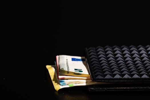 Euro banknotes in black wallet isolated.