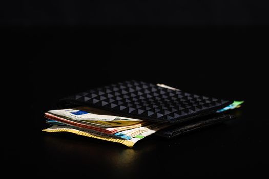 Euro banknotes in black wallet isolated.