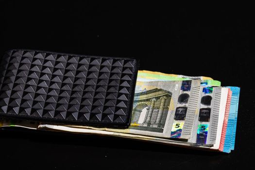 Euro banknotes in black wallet isolated.