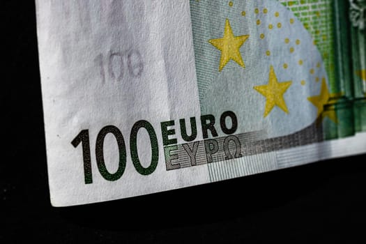 Selective focus on detail of euro banknotes. Close up macro detail of money banknotes, 100 euro isolated. World money concept, inflation and economy concept