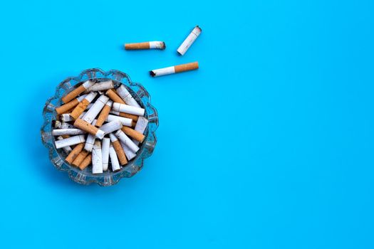 Cigarette butts on blue background.