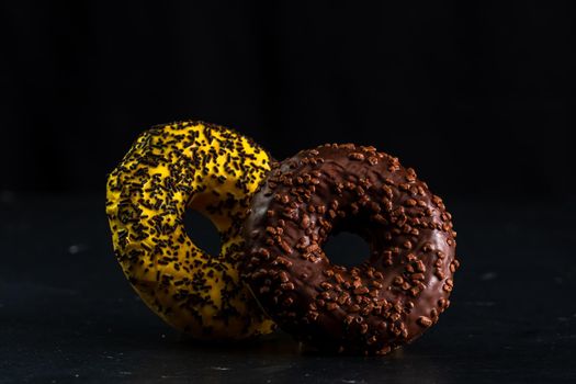 Glazed donuts with sprinkles isolated. Close up of colorful donuts.