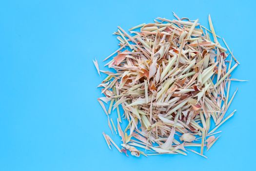 Organic dried lemongrass on blue background.