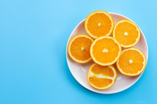 Sliced oranges on blue background. High vitamin C, Juicy and sweet.