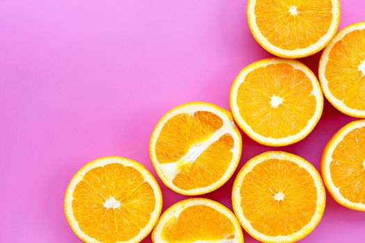 Sliced oranges on pink background. High vitamin C, Juicy and sweet.
