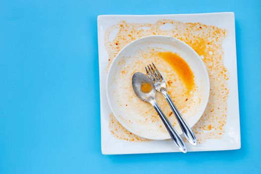 Dirty dishes on blue  background. Top view