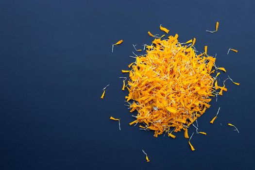 Marigold flower petals on dark background.