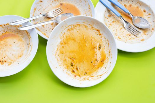 Dirty dishes on green background. Top view