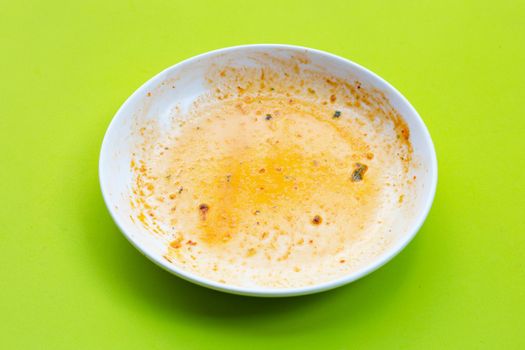 Dirty dish on green background. 
