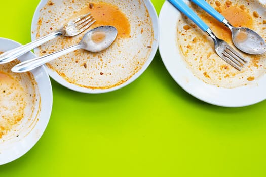 Dirty dishes on green background. Top view