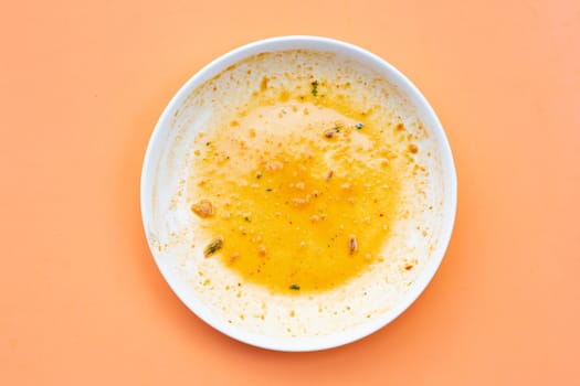 Dirty dish on orange background. Top view