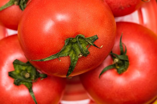 Close up of ripe red tomato, tomatoes background.