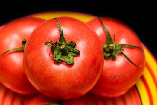 Close up of ripe red tomato, tomatoes background.