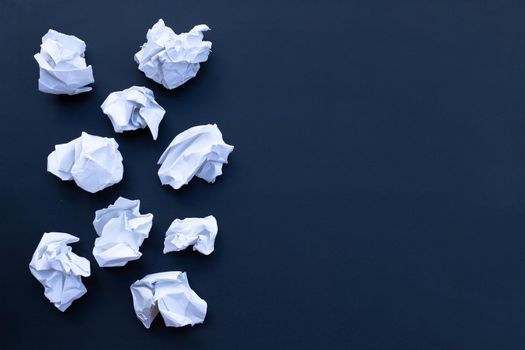 Crumpled white paper ball on black school chalkboard. Top view