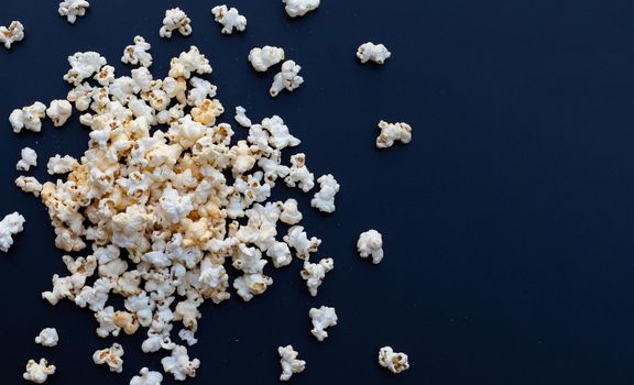 Popcorn on dark background. Copy space