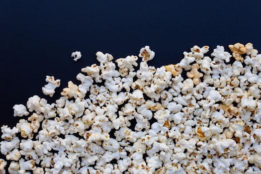 Popcorn on dark background. Copy space