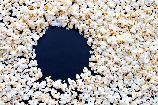 Popcorn on dark background. Copy space