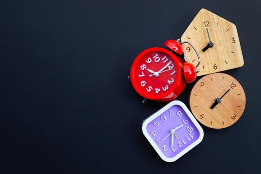 Clocks on dark background. Copy space