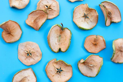 Dried apple slices on blue background