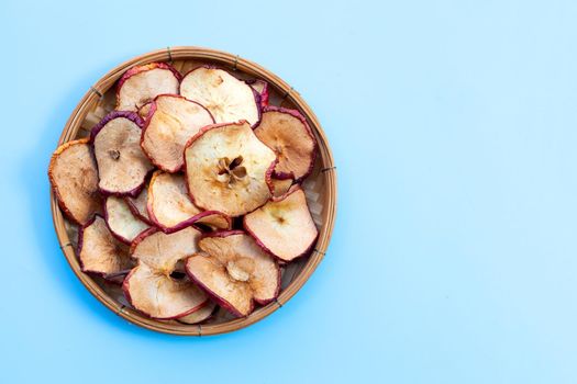 Dried apple slices on blue background