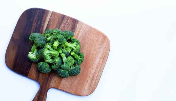 Fresh green broccoli on wooden cutting board