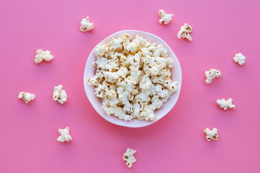 Popcorn on pink background. Copy space