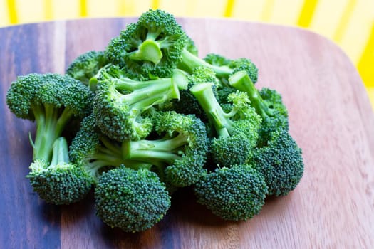 Fresh green broccoli on wooden cutting board