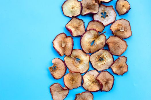 Dried apple slices on blue background