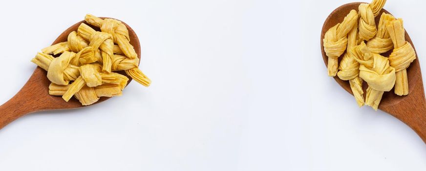 Dried bean curd knot on white background.